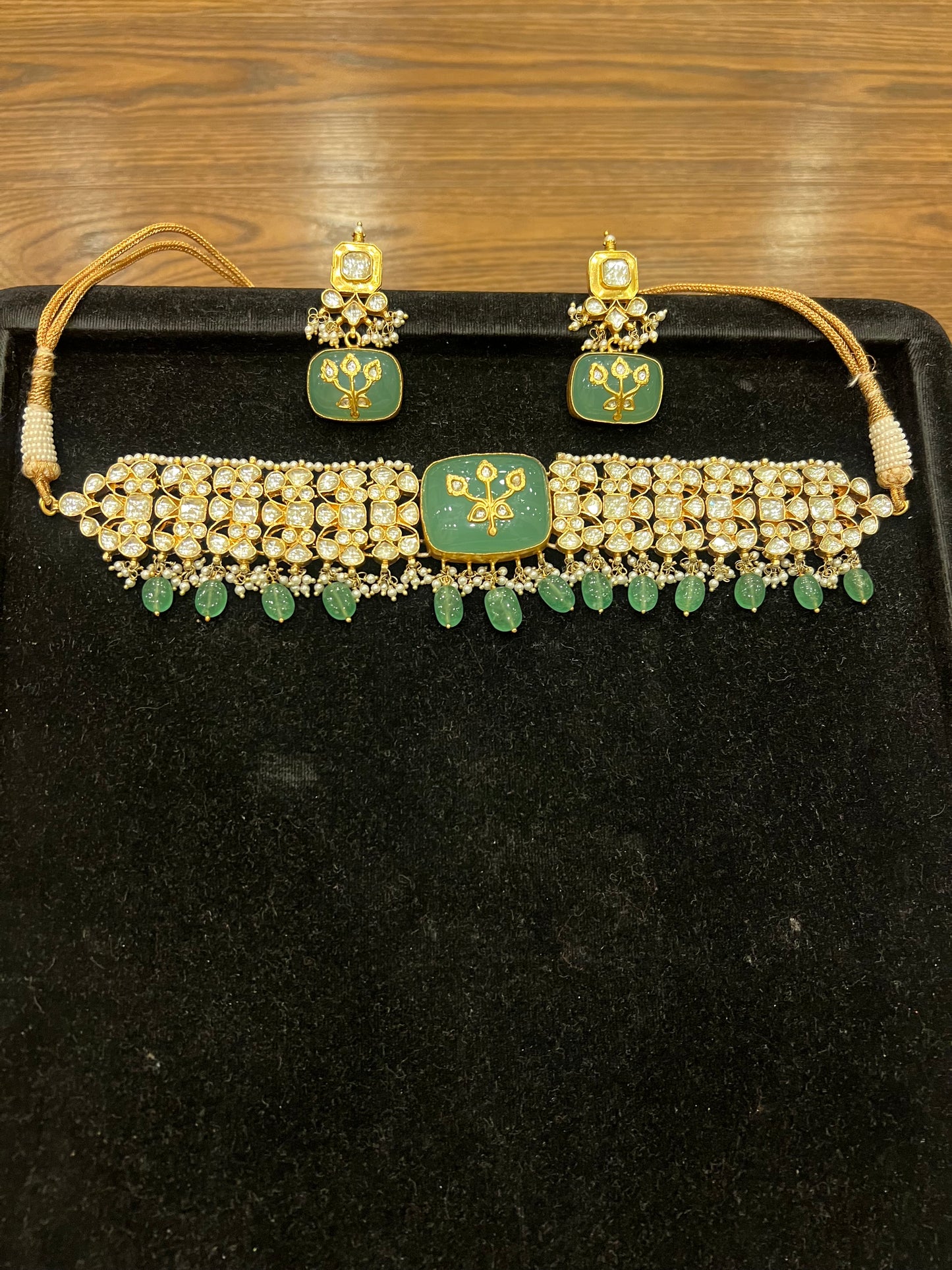 Carved gold motif on green stone choker