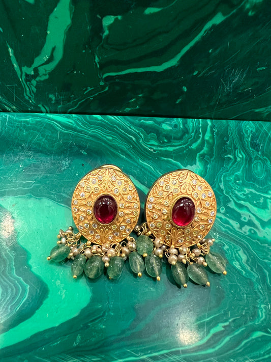 Oval engraved golden studs with ruby