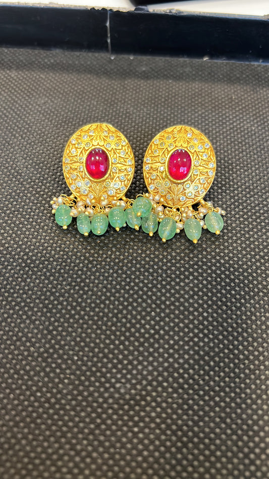 Oval engraved golden studs with ruby